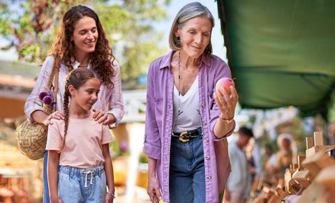 Woman at farmer's market with family